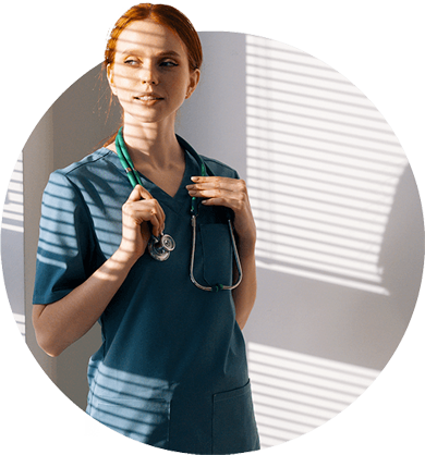 Nurse with a shadow of blinds cast over her looking pensively to the side