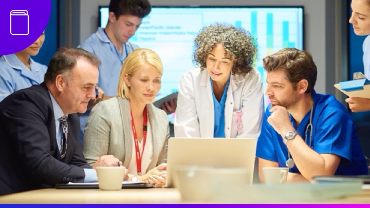 Thumbnail of a group of standing and seated medical professionals surrounding a laptop computer
