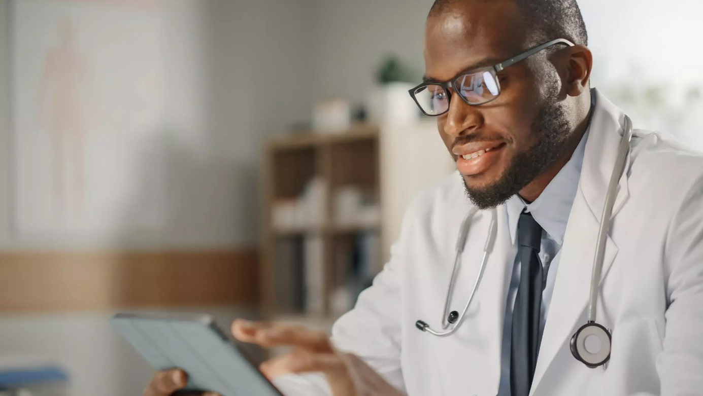 Thumbnail of a male doctor in white coat using a tablet
